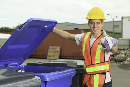 Volunteers sorting donated furniture and electronics for reuse